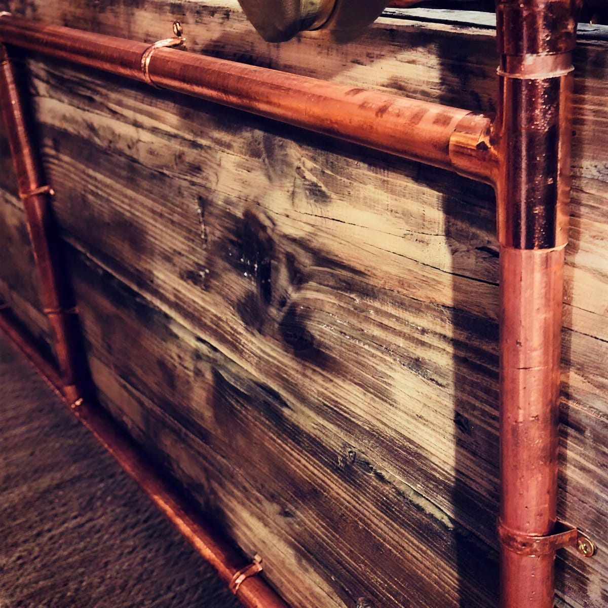 Custom furniture in reclaimed copper and pine.